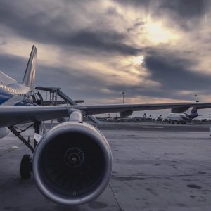 pexels-photo-912050-912050 A passenger airplane is parked on the tarmac at sunset, with another aircraft in the background.